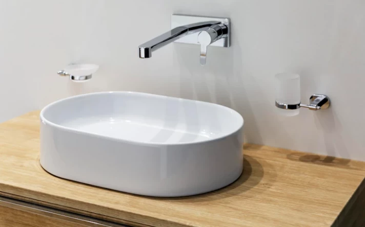 White sink with faucet on a wooden pedestal stylish scandinavian design